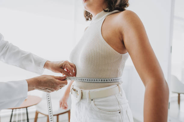 Woman measuring belly fat